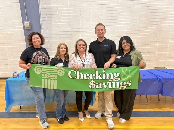 CapEd staff members at a Reality Town financial education table.